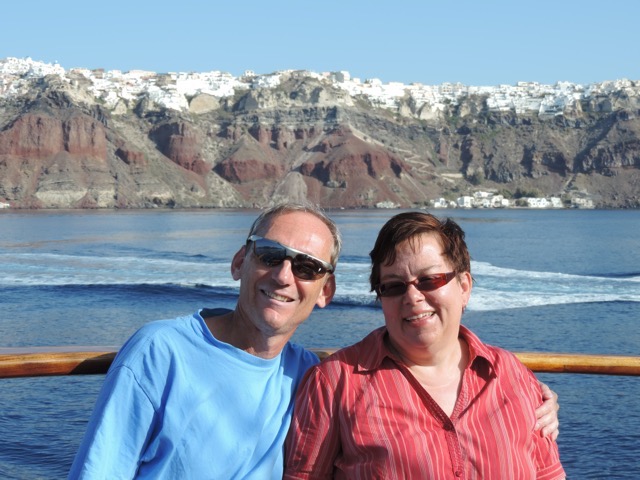 Our anniversary picture with our hotel and Oia in the background.